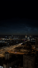 Khimki at night, noctilucent clouds over a lit cityscape
