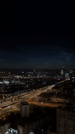 Khimki at night, noctilucent clouds over a lit cityscape