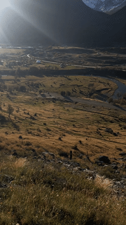 Woman rests on hillside near Ushuaia, Argentina