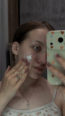 Woman documents skincare routine in Russian town selfie session