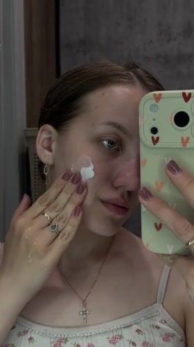 Woman documents skincare routine in Russian town selfie session