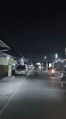 Night ride through busy streets of Desa Sawahan, Indonesia