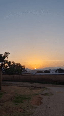 Early morning street life in an African city at sunrise