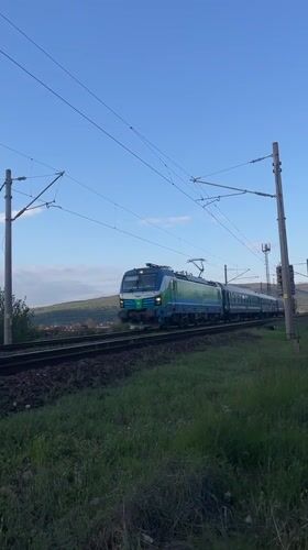 Rural Bulgaria evening scenes: train, jogger with dog, grazing horse