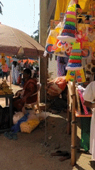 Street vendors sell goods at outdoor market in Badem