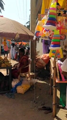 Street vendors sell goods at outdoor market in Badem