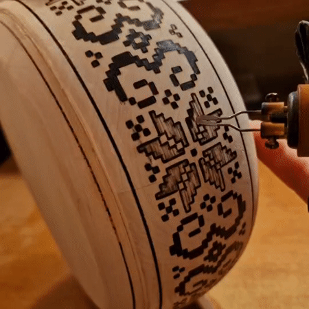 Pyrography in progress: intricate designs burned into decorative wood