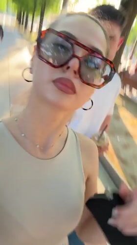 Woman tries sunglasses near street art in Bulgarian city