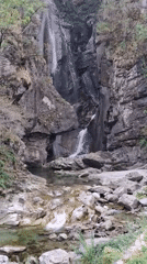 Tall waterfall cascades down mossy cliffs in Swiss Riviera