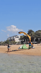 Kitesurfing and beach activity on a Bali morning