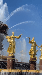 Golden fountain statues spray water in Moscow