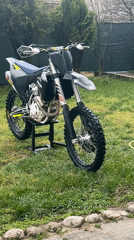 Dirt bike parked on grass lawn captured by witnesses