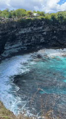 Tourist documents scenic Nusa Penida coastline views in Indonesia