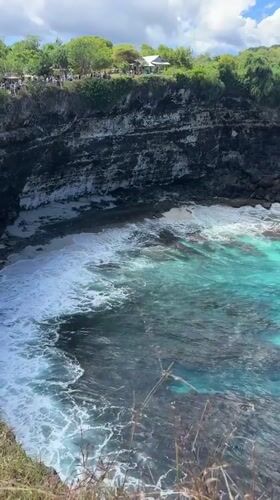 Tourist documents scenic Nusa Penida coastline views in Indonesia