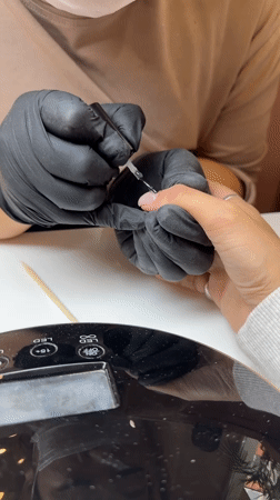 Nail technician provides manicure, pedicure services in Moscow salon