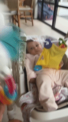 Baby care moments documented in Mengwi home with toys