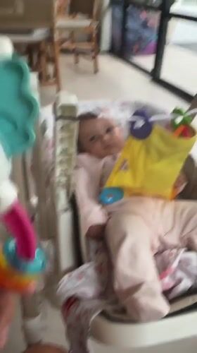 Baby care moments documented in Mengwi home with toys
