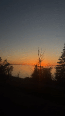 Sunset over water captured from vehicle in Hayes Township