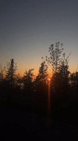 Sunset over water captured from vehicle in Hayes Township