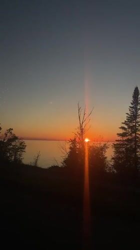 Sunset over water captured from vehicle in Hayes Township