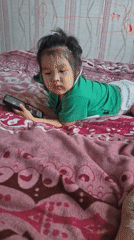 Toddler and child at home in Petropavl, Kazakhstan