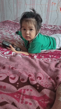 Toddler and child at home in Petropavl, Kazakhstan