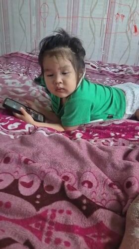 Toddler and child at home in Petropavl, Kazakhstan