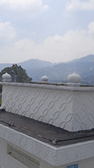 Ornate domed mosque in Cisarua's misty mountain landscape