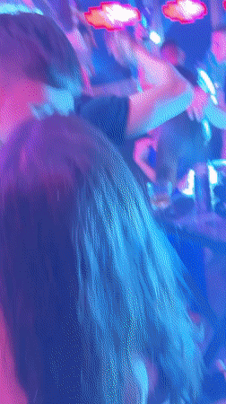 Nightclub crowd under colorful lights in Kiten, Bulgaria