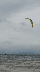 Kitesurfer spotted on choppy waters under cloudy morning sky