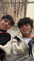 Two friends take selfies at Yerevan bus stop