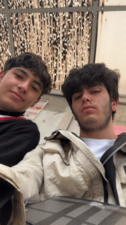 Two friends take selfies at Yerevan bus stop