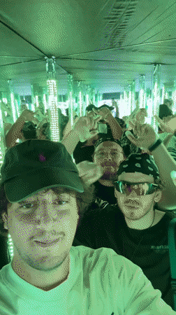 First-person view inside a reflective room with a crowd