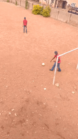 Pickup soccer on a dirt field in Bukuru, Nigeria