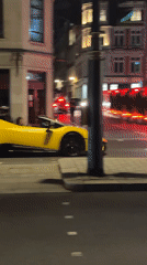 Late-night London streets: luxury cars, rollerbladers, lit-up squares