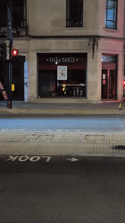 Late-night London streets: luxury cars, rollerbladers, lit-up squares