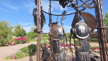 Garden walks and art installations with roses and sculptures