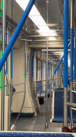 Nearly empty Moscow metro car, blue interior, evening ride