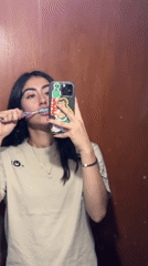 Woman takes selfie while brushing teeth in Puebla bathroom