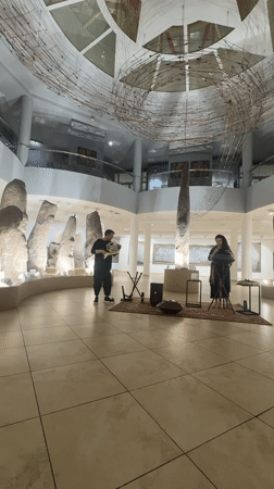 Musical performance among ancient stone artifacts in Abakan museum