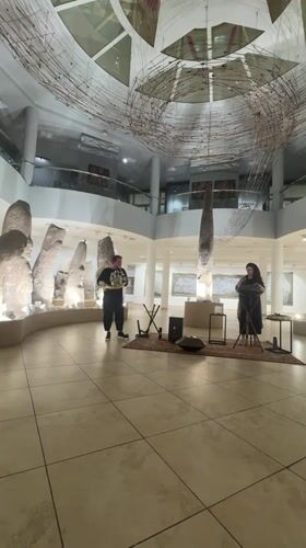 Musical performance among ancient stone artifacts in Abakan museum