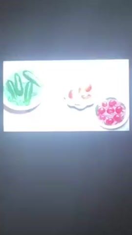 The video shows a clip from the animated series Masha and the Bear. A red bear is shown eating food from a plate and drinking from a cup. Dishes of cherries and pickles are also shown. The bear appears to be outdoors, with a golden samovar visible in the background.