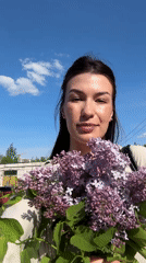 Woman enjoys lilac blooms in springtime Chaikovsky photo session