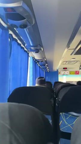 This media file appears to be a compilation of short video clips taken from inside a vehicle, possibly a bus or train, as it travels through a landscape in Kazakhstan.

The first clip shows the interior of the vehicle, with blue curtains and overhead compartments visible. The focus is on the back of several passengers, one of whom is wearing a dark hat. This suggests a journey in progress.

The subsequent clips transition to an outdoor view through the vehicle's windows. The scene depicts a vast, open landscape with dry, sparse vegetation, indicative of a steppe or arid environment. The ground appears to be rough and possibly dusty, with tire tracks suggesting off-road travel or a dirt road. The sky is dramatic, filled with a mix of bright blue patches and heavy, grey clouds, hinting at changeable weather conditions, possibly before or after a storm.

The overall impression is one of travel through a remote and sparsely populated area under a dynamic sky. There is no visible text in any of the clips. The camera work is amateur, suggesting personal documentation of a trip. The mood conveyed is one of observation and movement, with the focus on the changing scenery and the experience of transit.