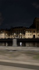 Nighttime drive through European city passes Lomonosov Hotel, waterfront