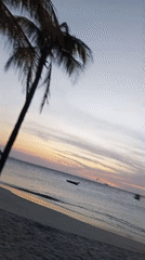 Sunset beach scenes with moored boats captured in Pedro González