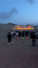 Desert camping group enjoys circle dancing, bonfires near Dunhuang