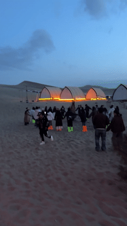 Desert camping group enjoys circle dancing, bonfires near Dunhuang