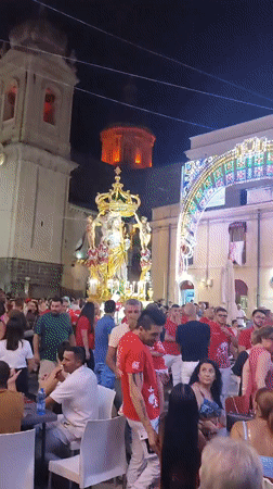 Nighttime religious procession and fireworks in Militello, Sicily