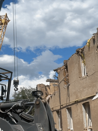 Demolition crews clear war-damaged building rubble in Kharkiv